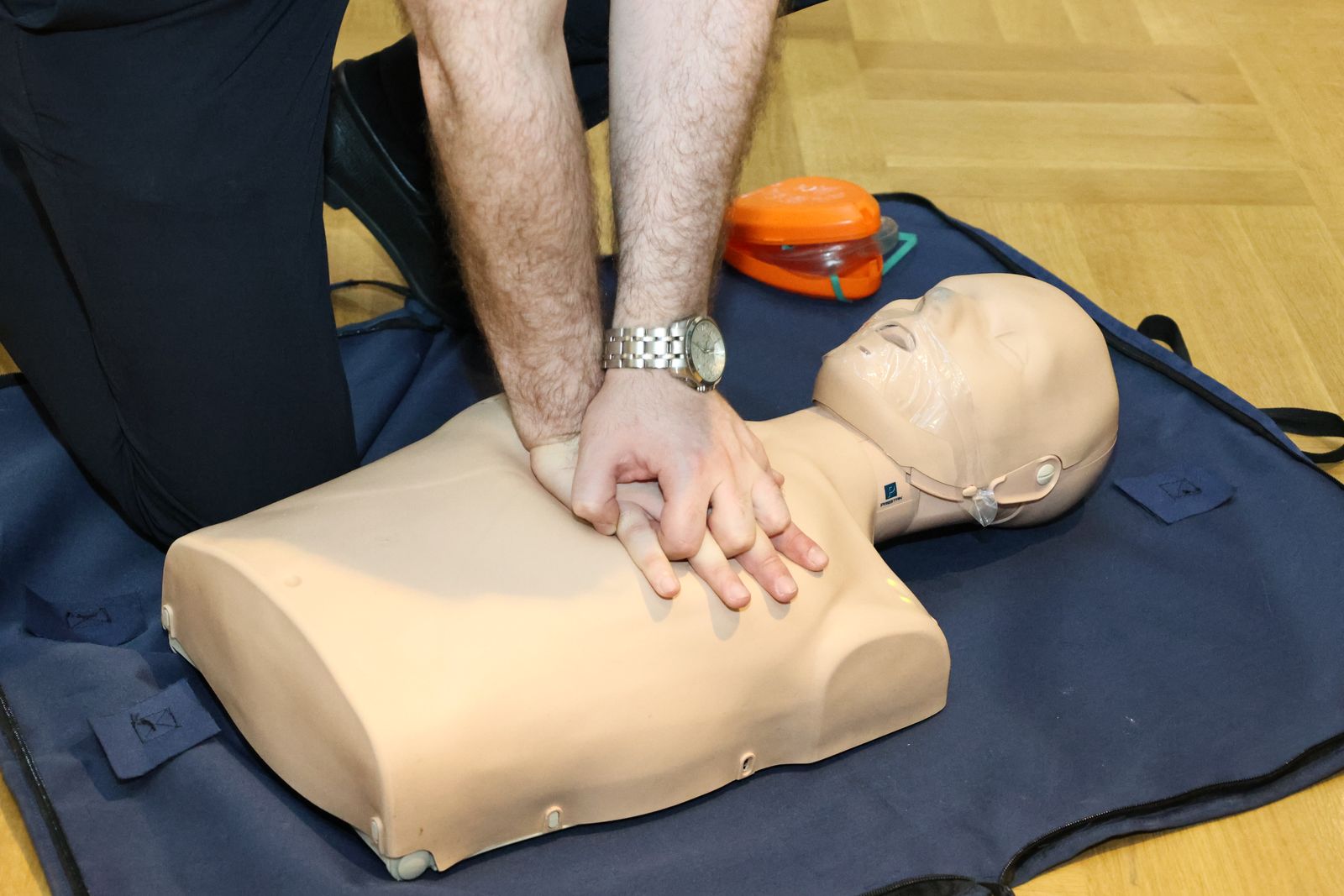 CPR practice on a training manikin during a first aid course