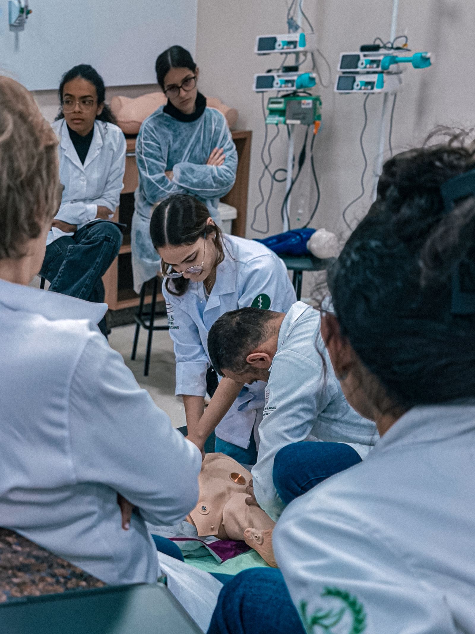 A group practicing CPR together on training manikins